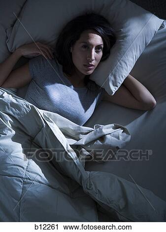 Woman in bed in the dark View Large Photo Image Stock Image - Woman in bed in the dark. Fotosearch