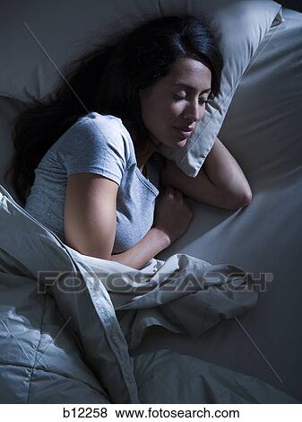 Woman in bed in the dark View Large Photo Image Stock Photo - Woman in bed in the dark. Fotosearch