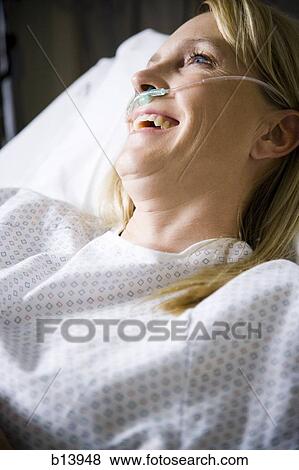 Stock Photo - Woman in hospital with respirator smiling. Fotosearch