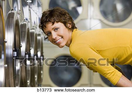 Woman in Laundromat smiling View Large Photo Image Stock Image - Woman in Laundromat smiling. Fotosearch