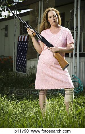 Woman in trailer park with shotgun View Large Photo Image Stock Image - Woman in trailer park with shotgun. Fotosearch