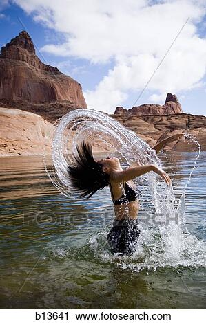 Woman in water with rock formations View Large Photo Image Stock Image - Woman in water with rock formations. Fotosearch