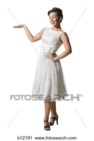 Stock Image - Woman in white dress gesturing. Fotosearch
