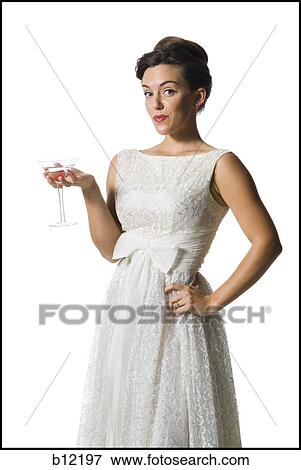 Woman in white dress holding martini glass View Large Photo Image Stock Photo - Woman in white dress holding martini glass. Fotosearch