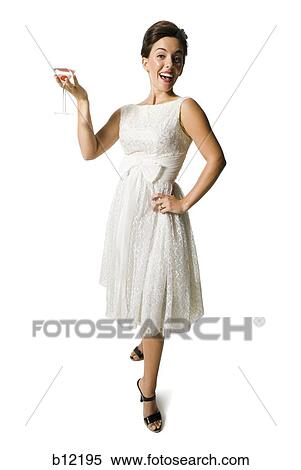 Stock Photography - Woman in white dress holding martini glass. Fotosearch