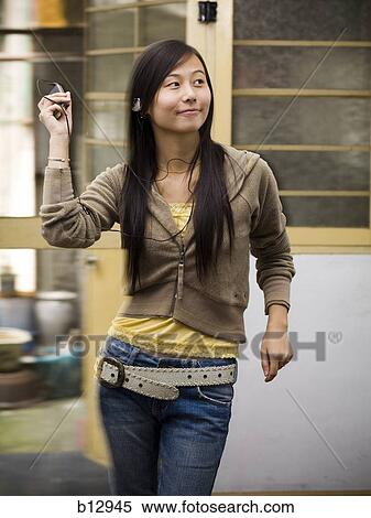 Woman listening to MP3 player View Large Photo Image Stock Photography - Woman listening to MP3 player. Fotosearch