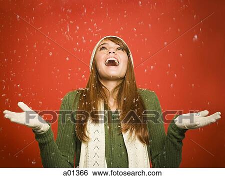 Woman looking up at snow falling View Large Photo Image Stock Photograph - Woman looking up at snow falling. Fotosearch