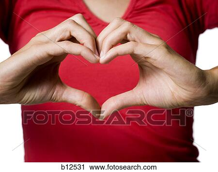 Woman making a heart shape symbol with her hands View Large Photo Image Stock Image - Woman making a heart shape symbol with her hands. Fotosearch