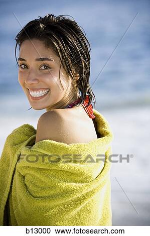 Woman on beach wrapped in a towel View Large Photo Image Stock Image - Woman on beach wrapped in a towel. Fotosearch