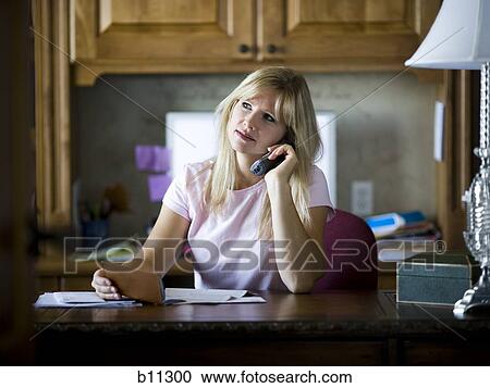 Woman paying bills over telephone View Large Photo Image Stock Image - Woman paying bills over telephone. Fotosearch