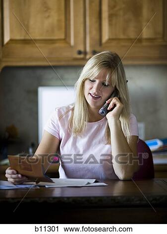 Woman paying bills over telephone View Large Photo Image Stock Image - Woman paying bills over telephone. Fotosearch