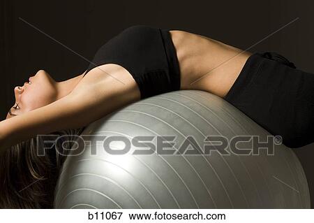Woman performing Pilates exercises View Large Photo Image Stock Photo - Woman performing Pilates exercises. Fotosearch