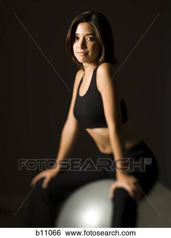 Woman performing Pilates exercises View Large Photo Image Stock Photograph - Woman performing Pilates exercises. Fotosearch