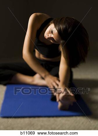 Stock Photo - Woman performing stretching exercises. Fotosearch