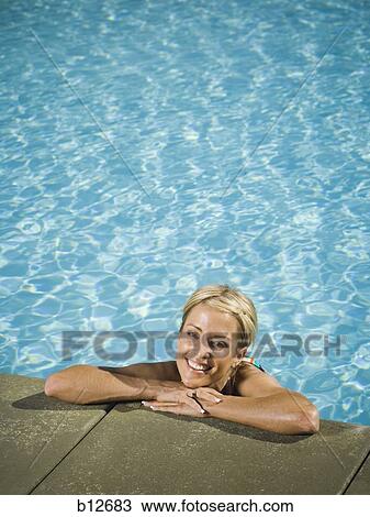 Woman posing in a swimming pool View Large Photo Image Stock Image - Woman posing in a swimming pool. Fotosearch