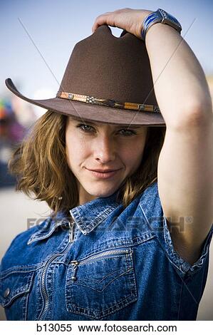 Stock Photography - Woman posing in cowboy hat. Fotosearch