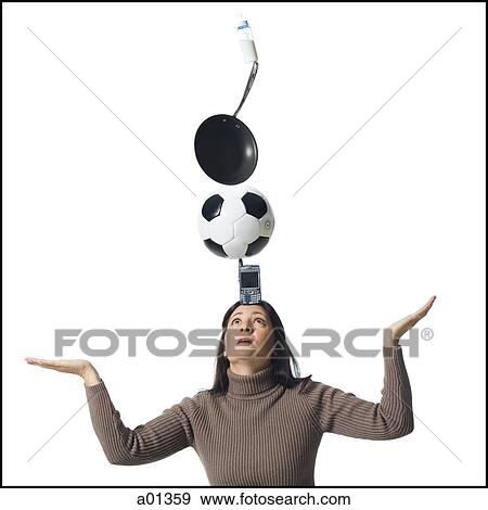Woman precariously balancing items on her head View Large Photo Image Stock Photo - Woman precariously balancing items on her head. Fotosearch