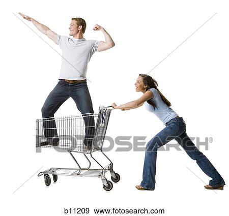 Woman pushing shopping cart with boyfriend inside View Large Photo Image Stock Photo - Woman pushing shopping cart with boyfriend inside. Fotosearch
