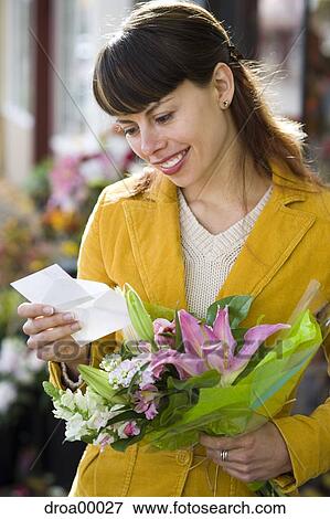 Stock Photo - Woman receiving bouquet of flowers. Fotosearch