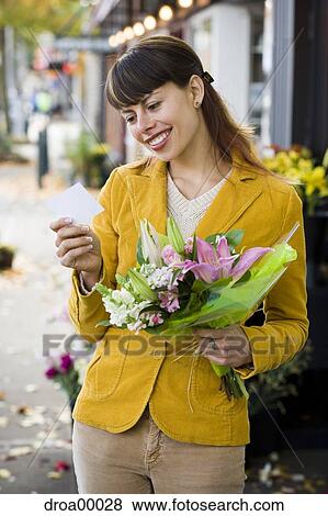 Stock Photo - Woman receiving bouquet of flowers. Fotosearch