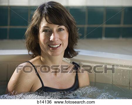 Stock Photograph - Woman relaxing in whirlpool. Fotosearch