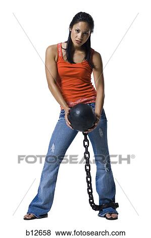 Stock Photo - Woman shackled to ball and chain. Fotosearch