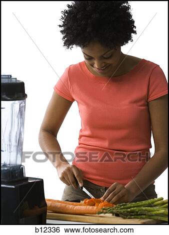 Woman slicing carrots View Large Photo Image Stock Photograph - Woman slicing carrots. Fotosearch