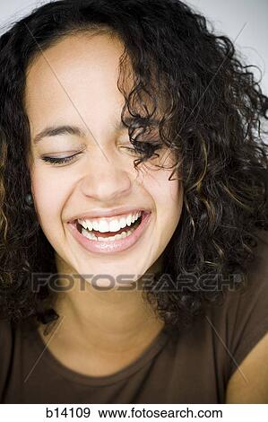 Stock Photo - Woman smiling with eyes closed. Fotosearch