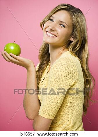 Woman smiling with green apple View Large Photo Image Stock Photo - Woman smiling with green apple. Fotosearch