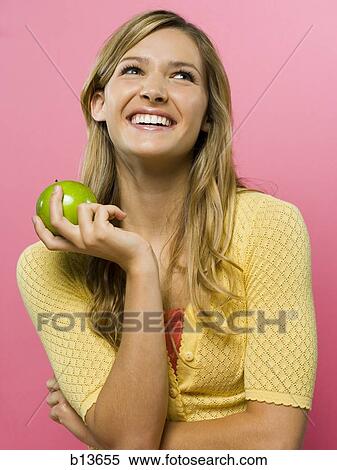 Woman smiling with green apple View Large Photo Image Stock Photography - Woman smiling with green apple. Fotosearch