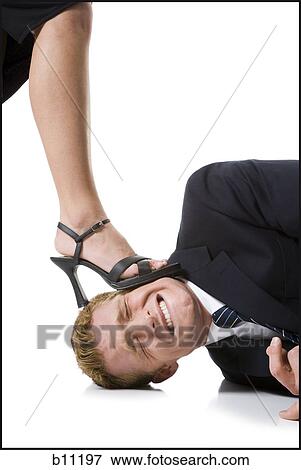 Woman stepping on man's head View Large Photo Image Stock Photo - Woman stepping on man's head. Fotosearch