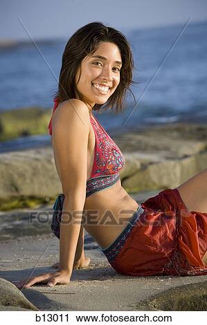 Woman sunbathing on beach View Large Photo Image Stock Image - Woman sunbathing on beach. Fotosearch
