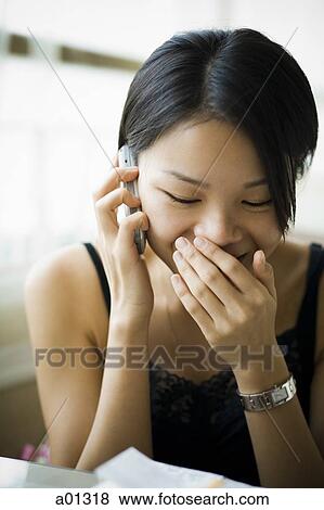 Woman talking on cell phone and laughing View Large Photo Image Stock Photo - Woman talking on cell phone and laughing. Fotosearch