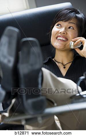 Stock Image - Woman talking on cell phone. Fotosearch