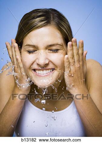 Woman washing face View Large Photo Image Stock Image - Woman washing face. Fotosearch