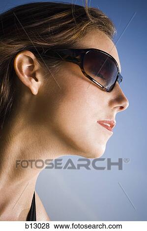 Stock Photo - Woman wearing sunglasses. Fotosearch