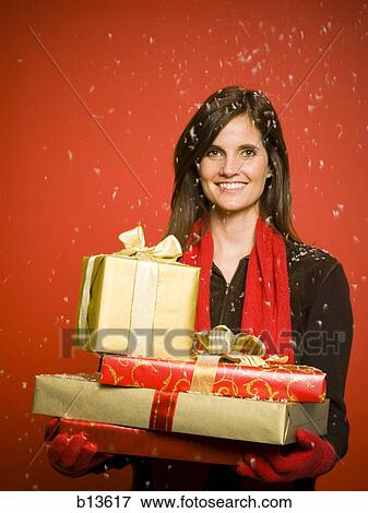 Woman with Christmas gifts in snow View Large Photo Image Stock Photo - Woman with Christmas gifts in snow. Fotosearch