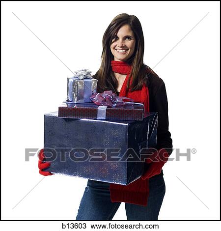 Stock Image - Woman with Christmas gifts smiling. Fotosearch
