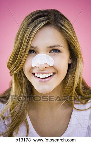 Stock Photo - Woman with cleansing strip on nose. Fotosearch