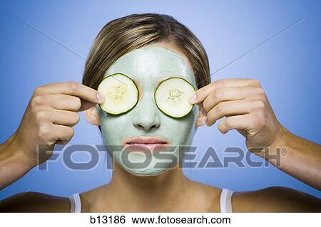 Woman with facial mask and cucumber slices View Large Photo Image Stock Photograph - Woman with facial mask and cucumber slices. Fotosearch