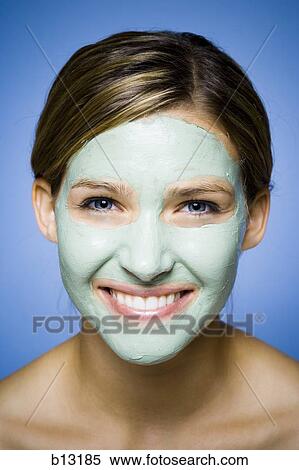 Stock Photography - Woman with facial mask smiling. Fotosearch