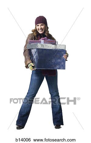 Stock Photograph - Woman with gifts wearing toque smiling. Fotosearch