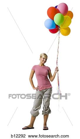 Woman with helium balloons View Large Photo Image Stock Image - Woman with helium balloons. Fotosearch