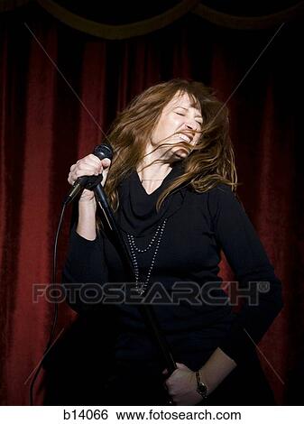 Woman with microphone View Large Photo Image Stock Photograph - Woman with microphone. Fotosearch