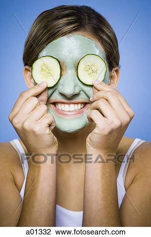 Woman with mud mask and cucumber slices smiling View Large Photo Image Stock Image - Woman with mud mask and cucumber slices smiling. Fotosearch