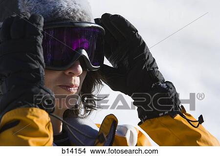 Picture - Woman with ski goggles outdoors in winter. Fotosearch