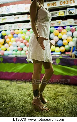 Stock Image - Woman with tattoo at fairground. Fotosearch