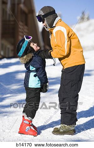 Woman with young girl in ski boots outdoors View Large Photo Image Stock Image - Woman with young girl in ski boots outdoors. Fotosearch