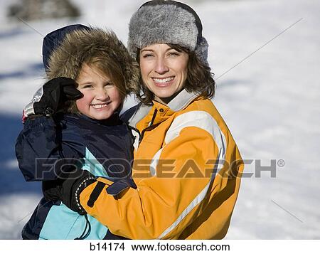 Picture - Woman with young girl outdoors in winter. Fotosearch