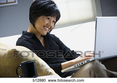 Woman working on laptop View Large Photo Image Stock Image - Woman working on laptop. Fotosearch